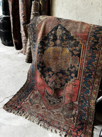 worn antique Persian rug